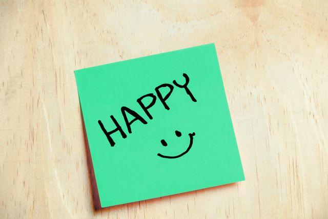 Karteczka samoprzylepna z napisem "Happy" i uśmiechem